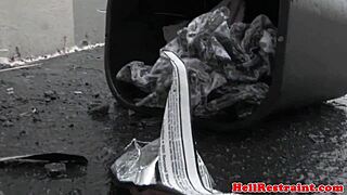 A BDSM submissive is punished with bastinado in the garage