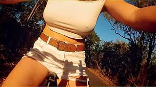 A hot mom is flashing her tits while riding a bike in public