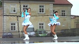 Two charming majorettes in a beautiful uniform are shining with beauty