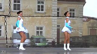Two charming majorettes in a beautiful uniform are shining with beauty