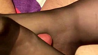 Giving The Hubby A Footjob In Black Stockings