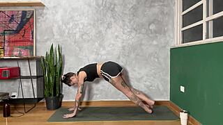 hot tattooed girl doing yoga at home