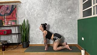 hot tattooed girl doing yoga at home