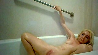 lucky blonde smokes while masturbating in bathtub