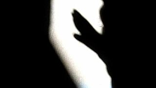 In the dim light, she explores chinese shadows technique during intense solo masturbation session