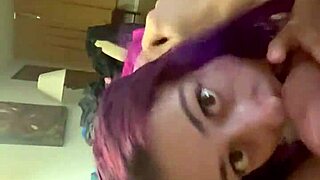 Purple haired girl sucks cock eagerly.