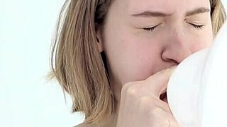 a young babe tries blowing and popping her first balloon in a looner session