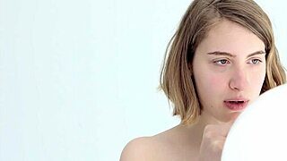 a young babe tries blowing and popping her first balloon in a looner session