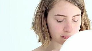 a young babe tries blowing and popping her first balloon in a looner session