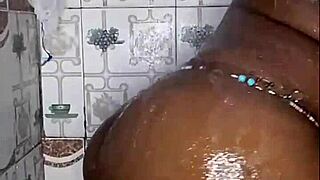 black thick ebony babe fucks and dances while bathing in the shower.