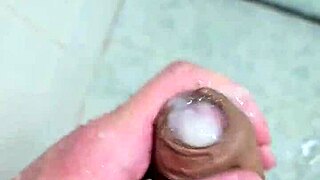 Young guy cums deliciously in the shower with neighbors watching