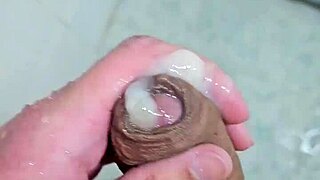 Young guy cums deliciously in the shower with neighbors watching