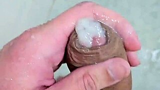 Young guy cums deliciously in the shower with neighbors watching