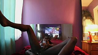 Alyx Fox, the black shemale, plays with her dildo in crossdressing fun