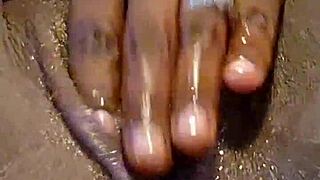 Ebony woman explores self-pleasure with toys at home