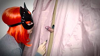 A ginger girl discovers a gloryhole and teases with a blowjob