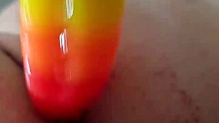 Chubby brunette uses rainbow dildo for anal gaping