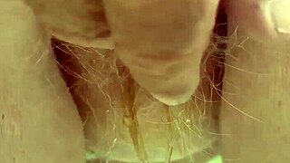 Redhead pees intensely through her hairy pussy