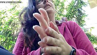 Nicoletta smokes in a public garden, pulling her big tits out of her shirt to show them