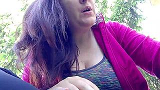 Nicoletta smokes in a public garden, pulling her big tits out of her shirt to show them