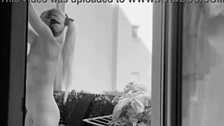Naked chubby woman hangs laundry on balcony so neighbors can watch her shaved pussy and big tits
