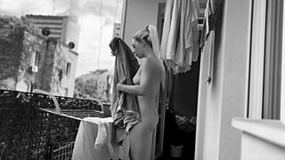 Naked chubby woman hangs laundry on balcony so neighbors can watch her shaved pussy and big tits