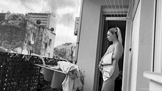 Naked chubby woman hangs laundry on balcony so neighbors can watch her shaved pussy and big tits