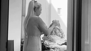 Naked chubby woman hangs laundry on balcony so neighbors can watch her shaved pussy and big tits