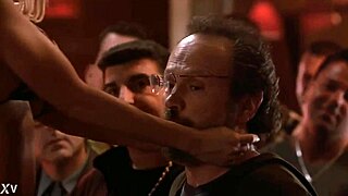 Gina Lynn performs a striptease, ripping her clothes to reveal big tits.