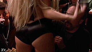 Gina Lynn performs a striptease, ripping her clothes to reveal big tits.