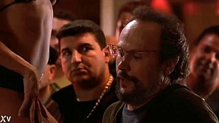 Gina Lynn performs a striptease, ripping her clothes to reveal big tits.