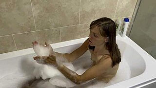 Brunette with small tits sings naked in the bath