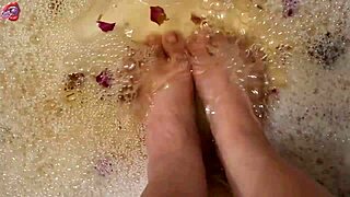 Skinny Tattooed Amateur Gently Washes Bare Feet with Rose Petals and Herbs in Homemade Video