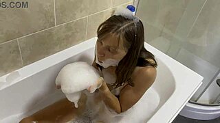 Brunette with small tits sings naked in the bath