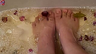 Skinny Tattooed Amateur Gently Washes Bare Feet with Rose Petals and Herbs in Homemade Video