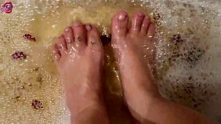 Skinny Tattooed Amateur Gently Washes Bare Feet with Rose Petals and Herbs in Homemade Video