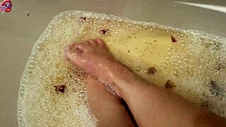 Skinny Tattooed Amateur Gently Washes Bare Feet with Rose Petals and Herbs in Homemade Video