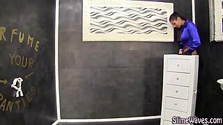 This European slut is masturbating and getting a messy bukkake facial at the gloryhole