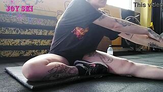 Alternative Girl Stretches At Gym.