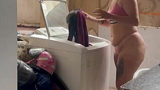 woman washes clothes with tits and pussy out