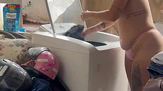 woman washes clothes with tits and pussy out
