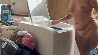 woman washes clothes with tits and pussy out