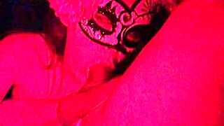 Masked girl sucks cock under red lights 😈