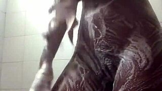 She masturbates in the soapy shower, feeling tight and wet.