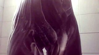 She masturbates in the soapy shower, feeling tight and wet.