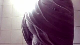 She masturbates in the soapy shower, feeling tight and wet.