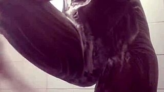 She masturbates in the soapy shower, feeling tight and wet.