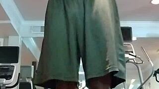 Athletic brunette performs pole dance in the dorm, showcasing her fitness and beauty to roommates