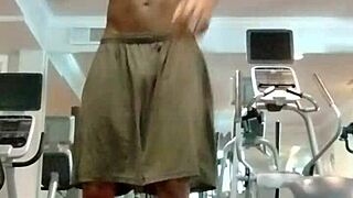 Athletic brunette performs pole dance in the dorm, showcasing her fitness and beauty to roommates