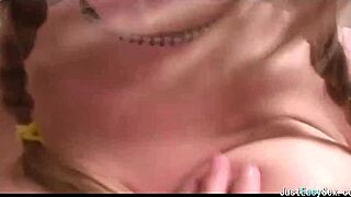 Pigtailed brunette feels pleasure playing with her big tits solo